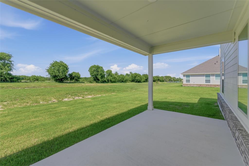 130 Fossil Canyon Drive Rhome, TX 76078 - Photo 20 of 25 Covered patio featuring a concrete slab and white support columns