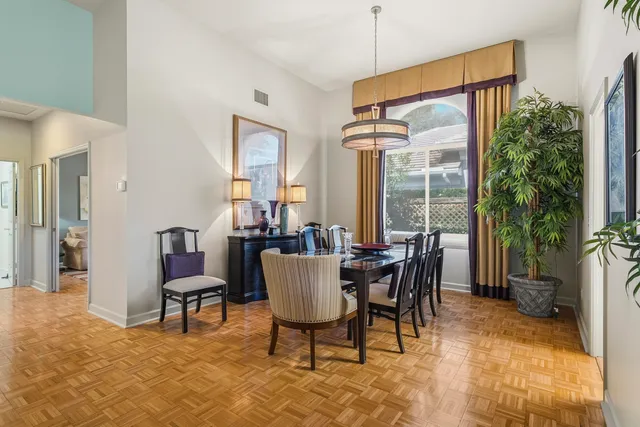 a room with stainless steel appliances granite countertop a refrigerator and a wooden floor