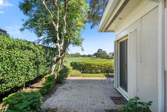an aerial view of a house with garden space and outdoor seating