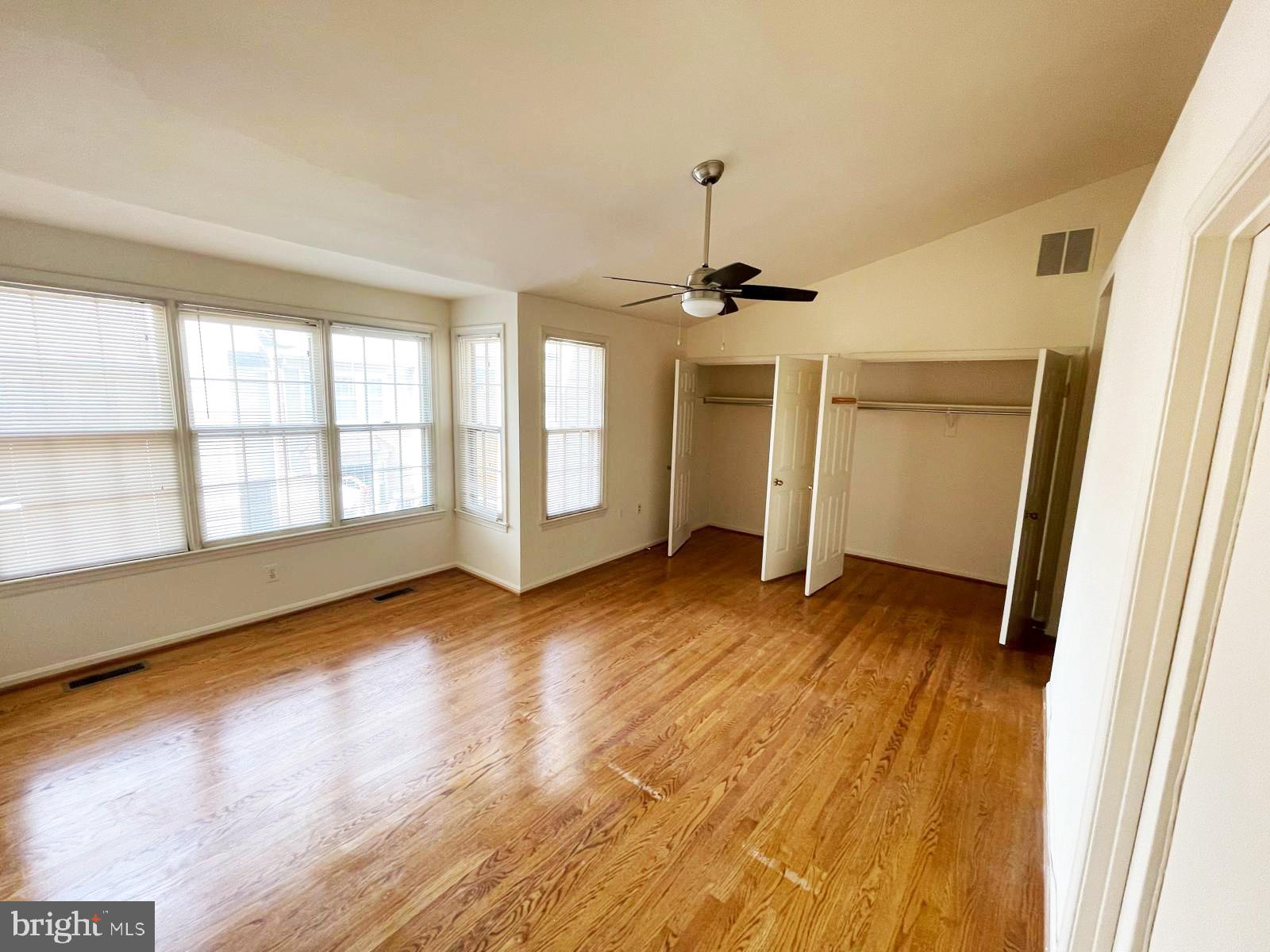 6510 Serenade Place Springfield, VA 22150 - Photo 21 of 29 an empty room with wooden floor and windows