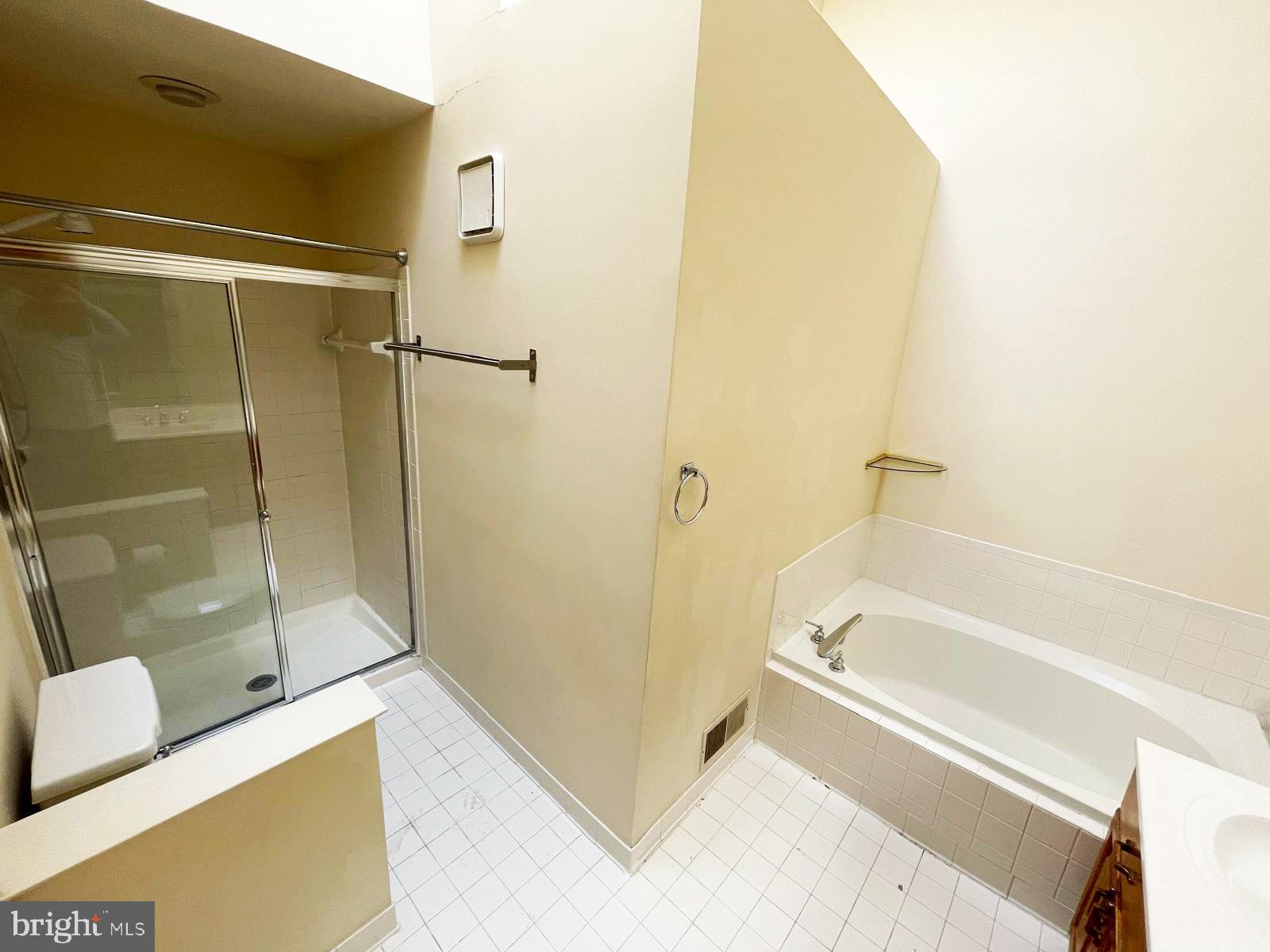 6510 Serenade Place Springfield, VA 22150 - Photo 23 of 29 a bathroom with a tub and shower