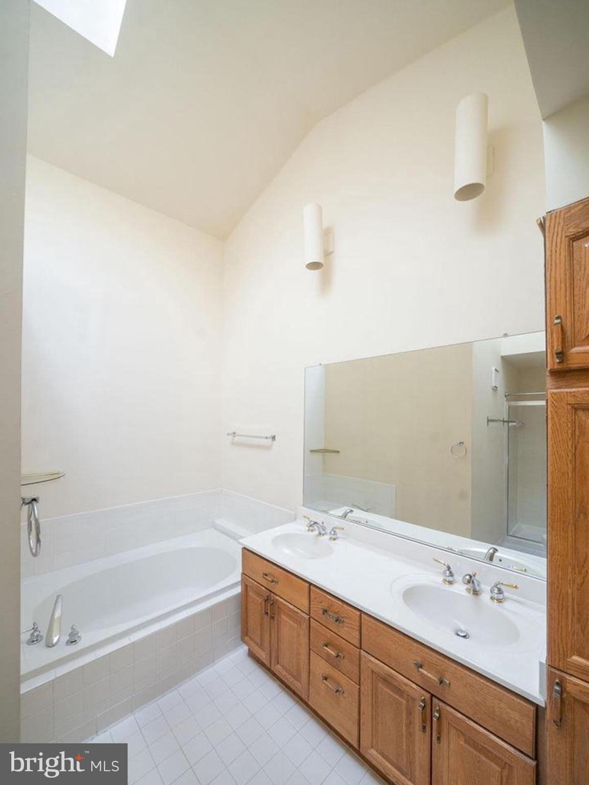 6510 Serenade Place Springfield, VA 22150 - Photo 24 of 29 a bathroom with a tub sink and mirror