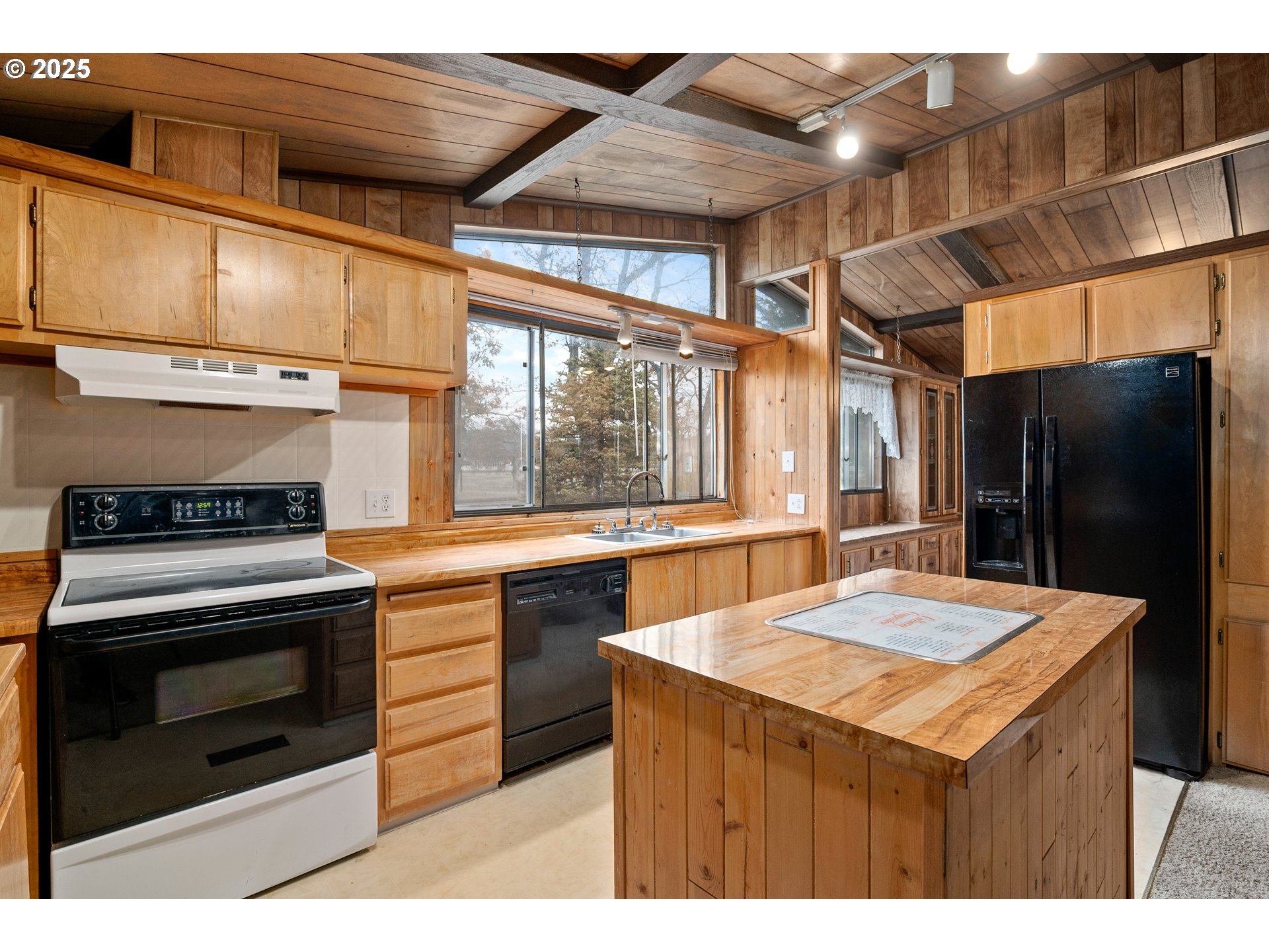 5209 Beagle Road White City, OR 97503 - Photo 11 of 48 a kitchen with stainless steel appliances kitchen island a table chairs and stove