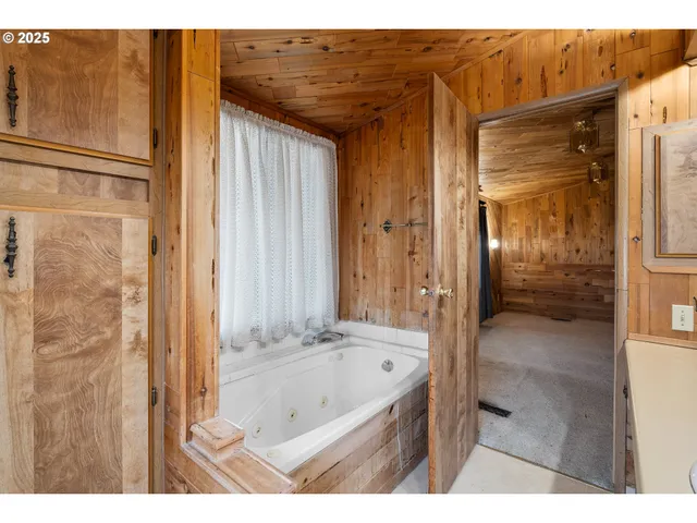 a bathroom with a tub shower and sink