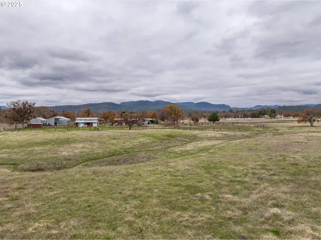 a front view of a house with a yard and lake view