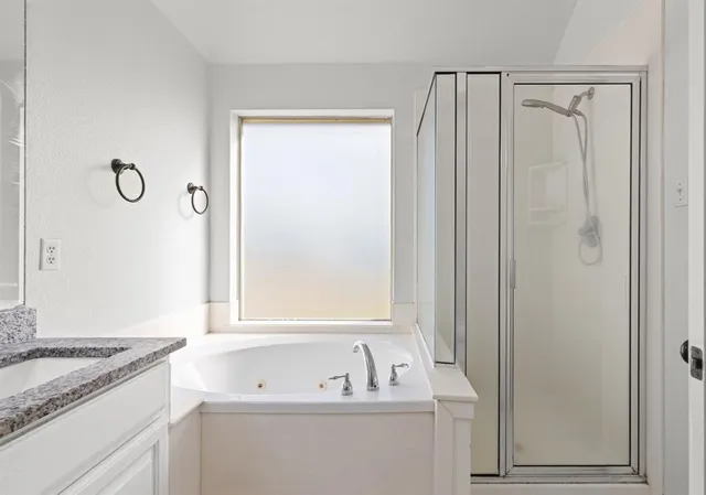 a bathroom with a sink a mirror and a bathtub