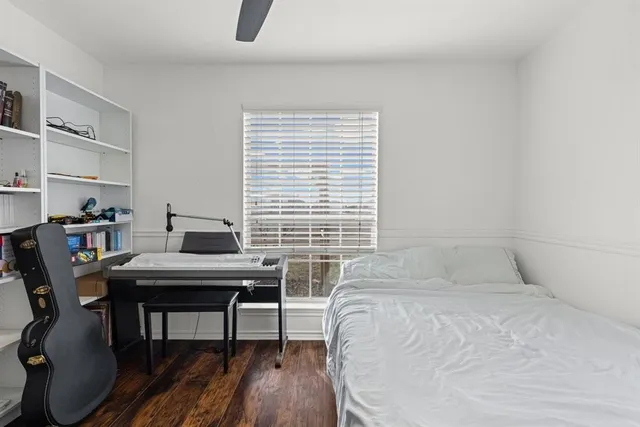 a bedroom with a bed and a desk