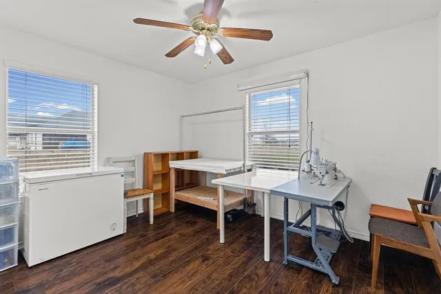 a view of a workspace with furniture window and wooden floor