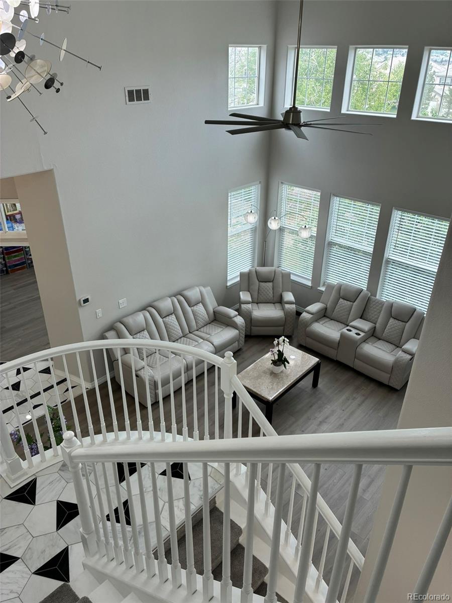 7242 South Rome Street Aurora, CO 80016 - Photo 6 of 33 a living room with furniture and windows