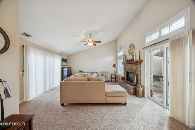 a living room with furniture and a fireplace