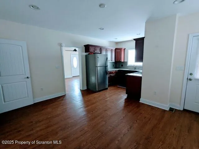 a kitchen with stainless steel appliances granite countertop a refrigerator and a sink