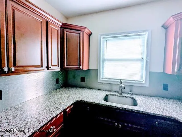 a kitchen with granite countertop a sink and a window