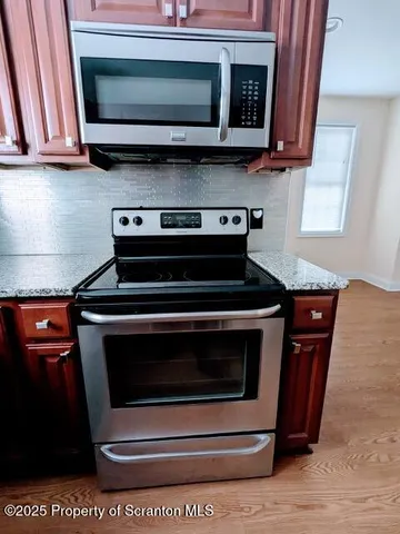 a stove top oven sitting inside of a kitchen