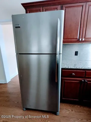 a view of a refrigerator in kitchen