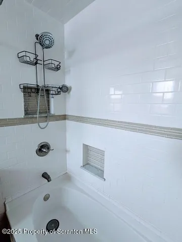a bathroom with a bathtub and shower