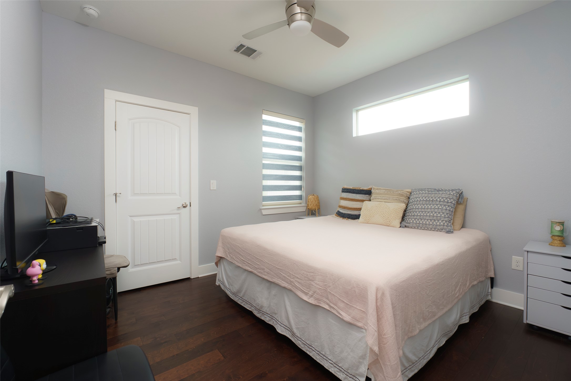 302 Delmar Avenue, Unit B Austin, TX 78752 - Photo 12 of 19 a bedroom with a bed and a chandelier