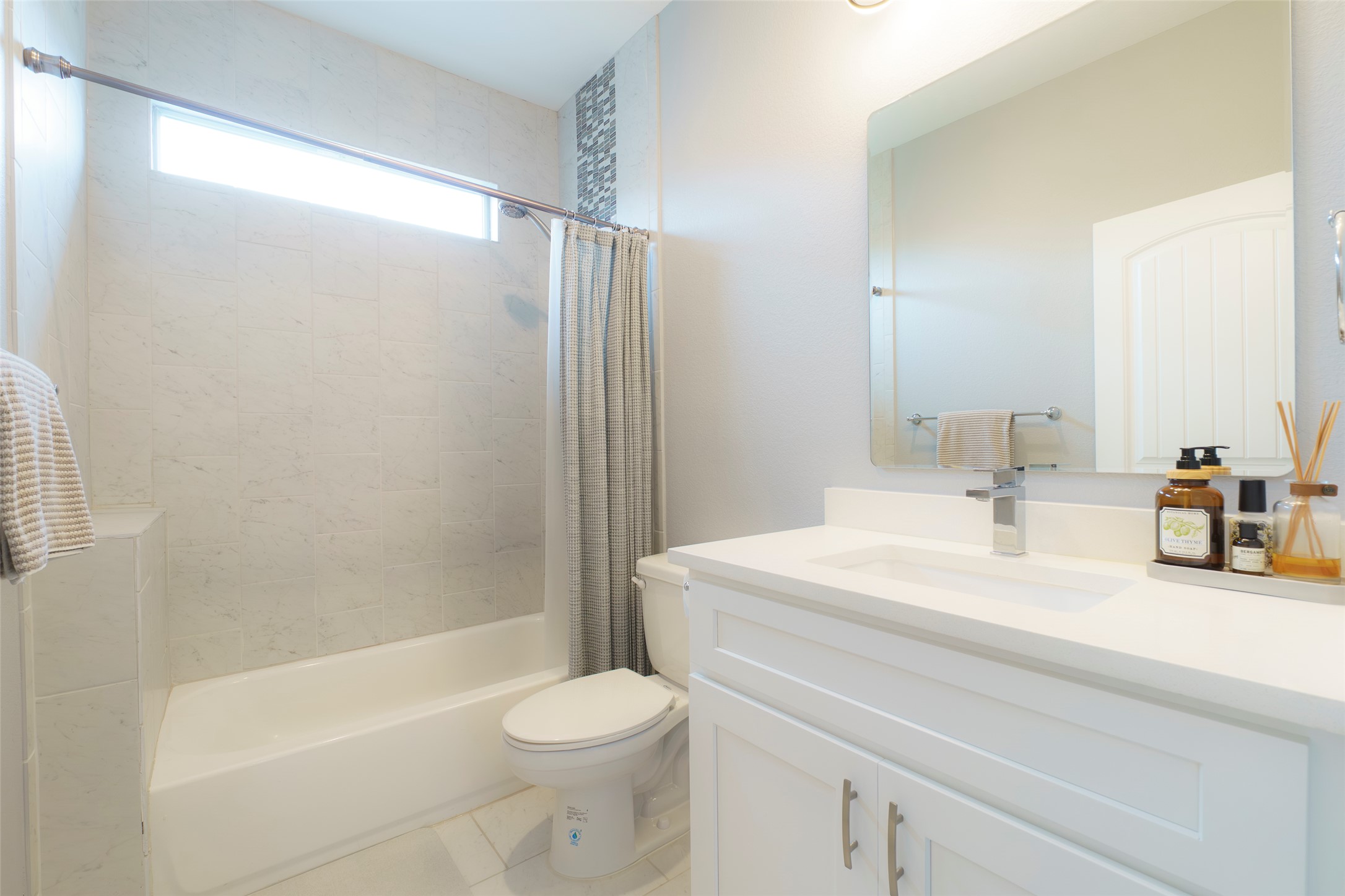 302 Delmar Avenue, Unit B Austin, TX 78752 - Photo 16 of 19 a bathroom with a sink a toilet a mirror a bathtub and shower