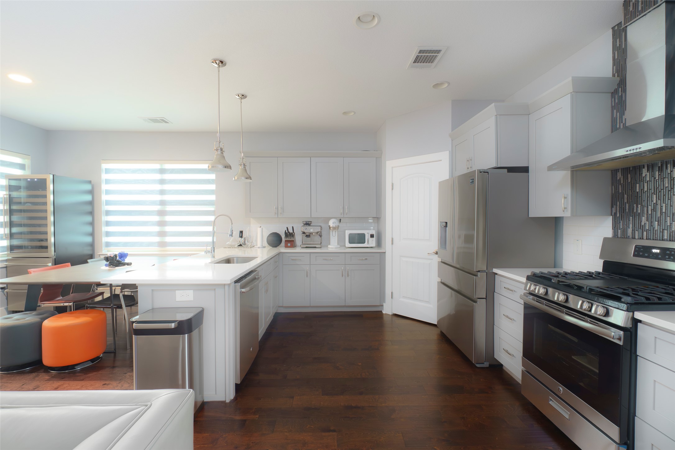 302 Delmar Avenue, Unit B Austin, TX 78752 - Photo 4 of 19 a kitchen with stainless steel appliances granite countertop a refrigerator a sink dishwasher a stove and white countertops with wooden floor