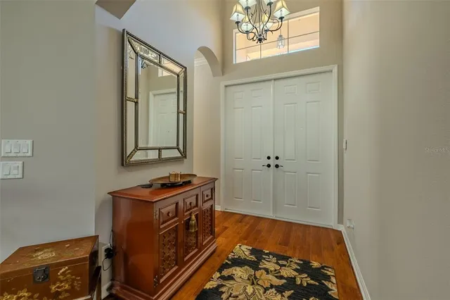 a view of a livingroom with wooden floor and a window