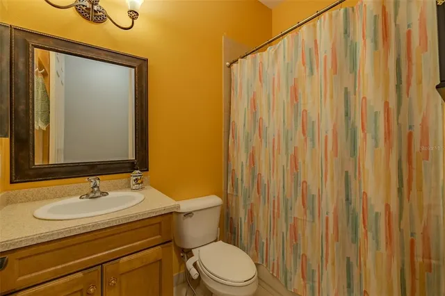 a spacious bathroom with a double vanity sink a large mirror and a shower