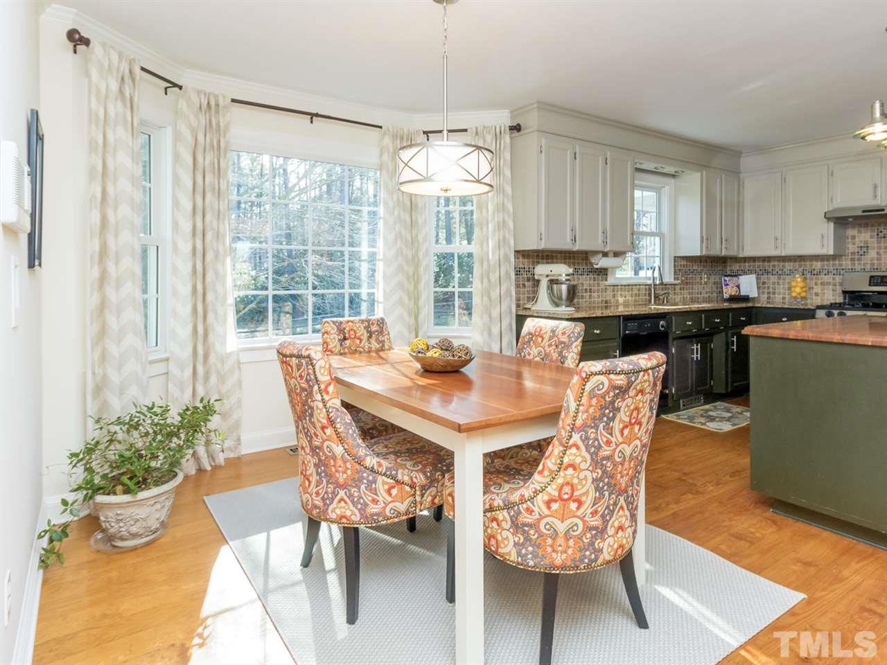 4108 Southall Road Raleigh, NC 27604 - Photo 11 of 25 a view of a dining room with furniture window and wooden floor