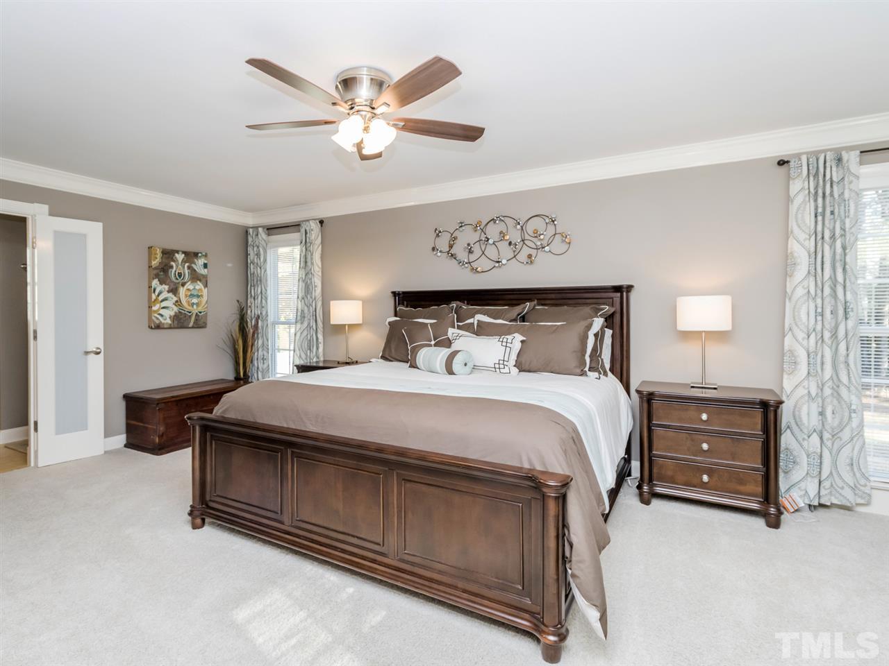 4108 Southall Road Raleigh, NC 27604 - Photo 12 of 25 a bedroom with a bed and a chandelier
