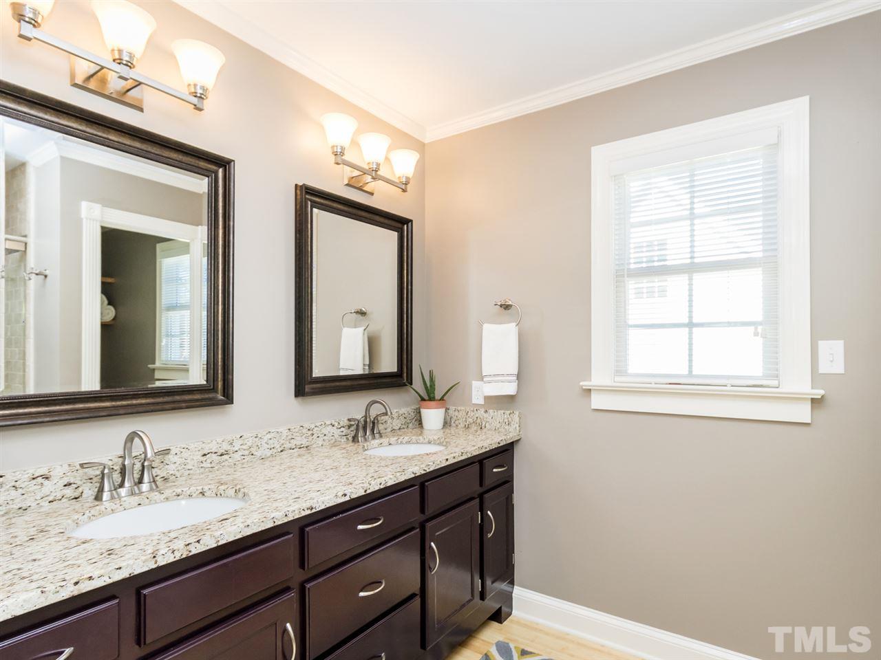 4108 Southall Road Raleigh, NC 27604 - Photo 13 of 25 a bathroom with a double vanity sink and a mirror