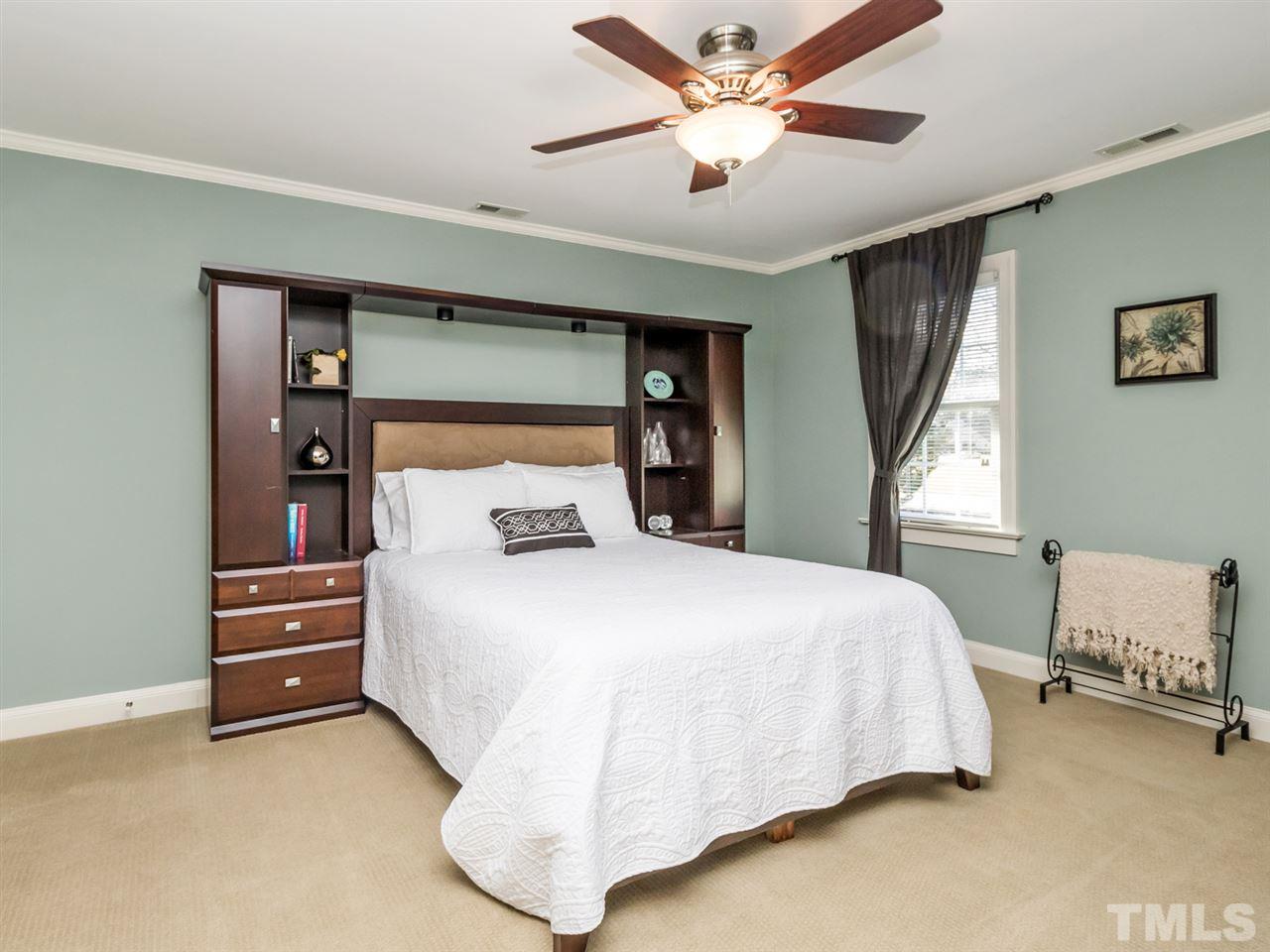 4108 Southall Road Raleigh, NC 27604 - Photo 17 of 25 a bedroom with a bed and a chandelier