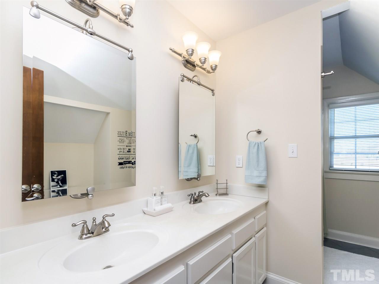 4108 Southall Road Raleigh, NC 27604 - Photo 20 of 25 a bathroom with a sink and a mirror