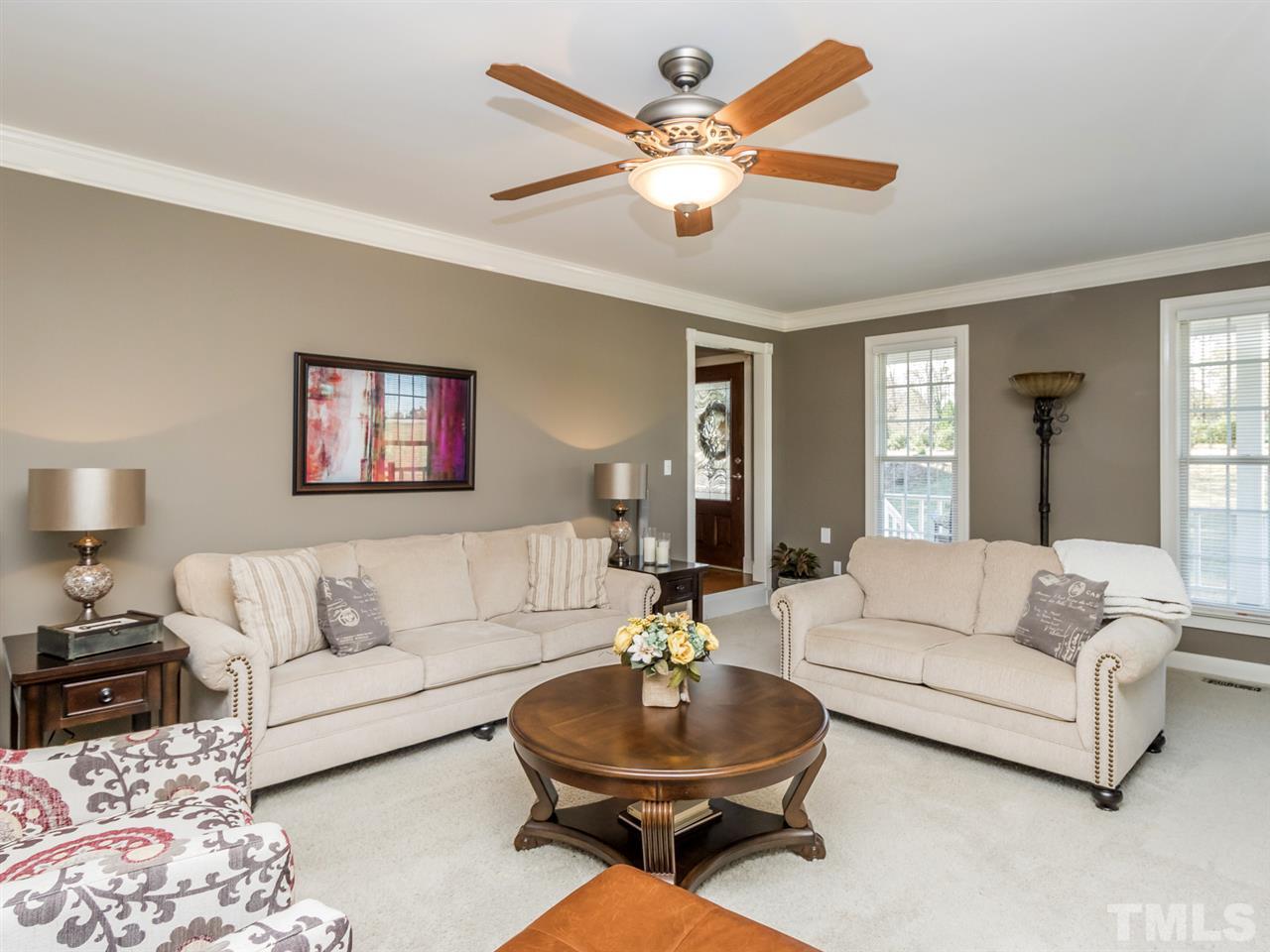 4108 Southall Road Raleigh, NC 27604 - Photo 7 of 25 a living room with furniture a rug and a lamp