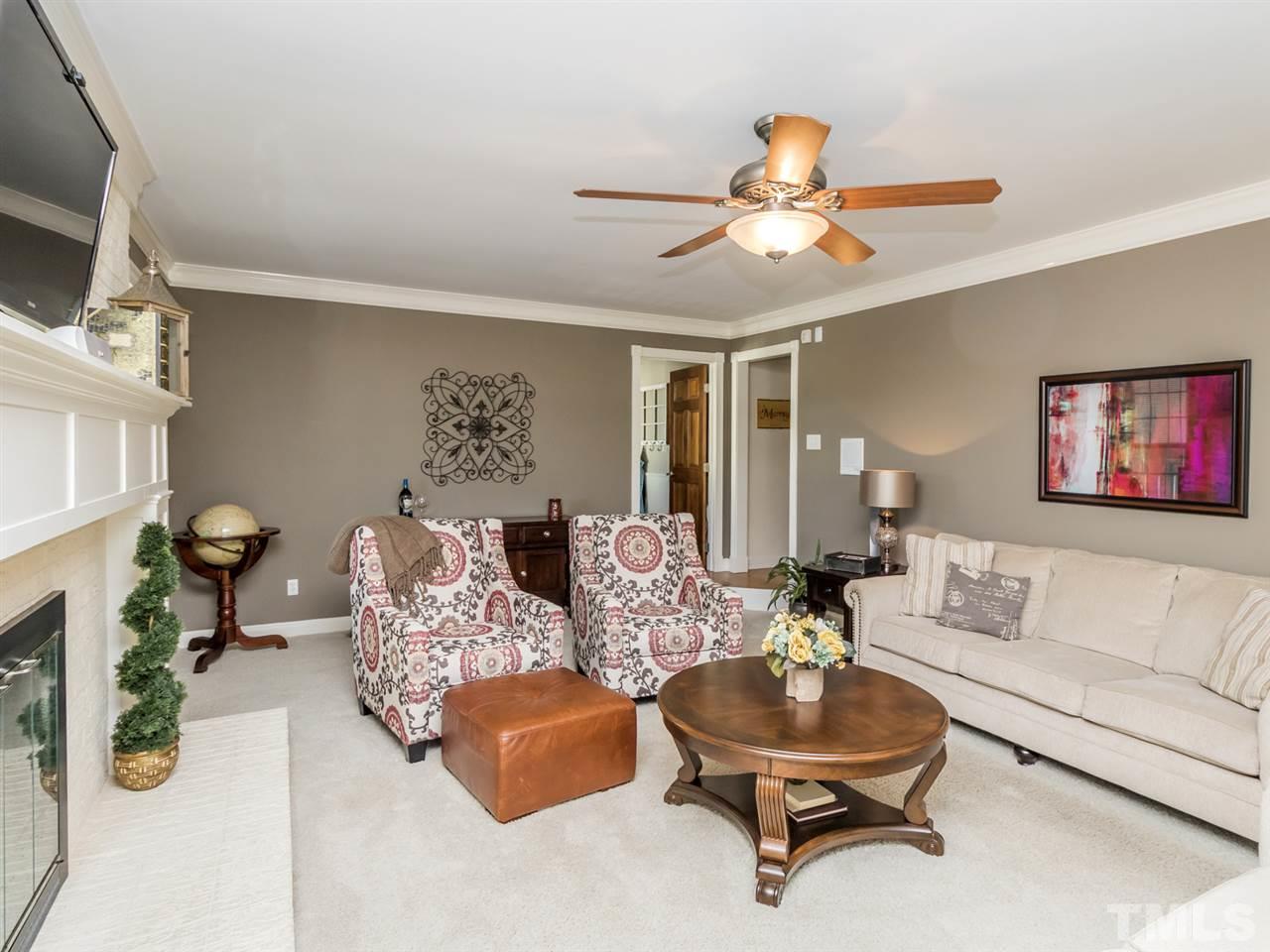 4108 Southall Road Raleigh, NC 27604 - Photo 8 of 25 a living room with furniture and a chandelier