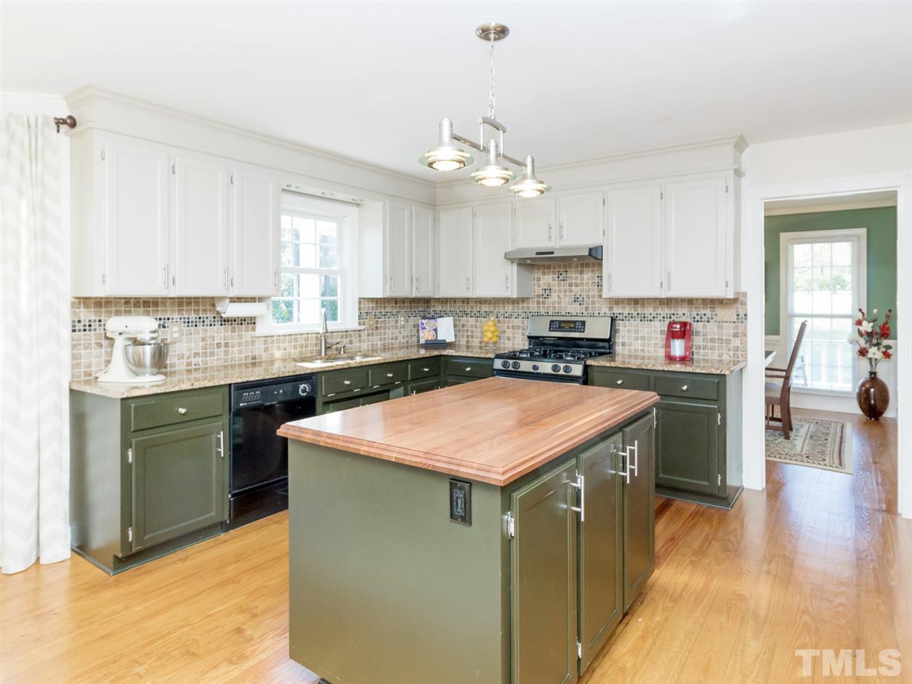 4108 Southall Road Raleigh, NC 27604 - Photo 9 of 25 a kitchen with stainless steel appliances granite countertop a sink stove and refrigerator