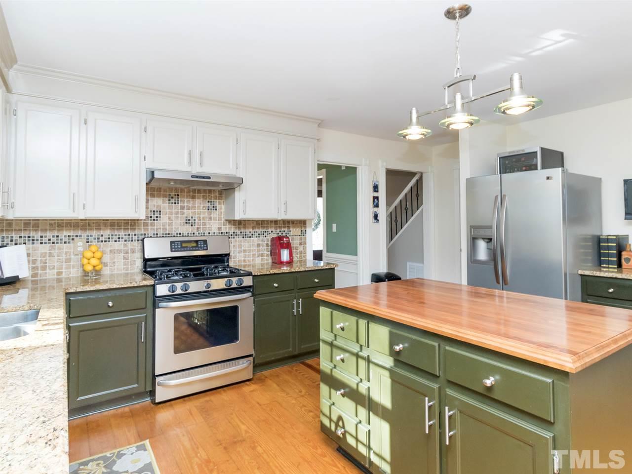 4108 Southall Road Raleigh, NC 27604 - Photo 10 of 25 a kitchen with stainless steel appliances granite countertop a sink stove and refrigerator