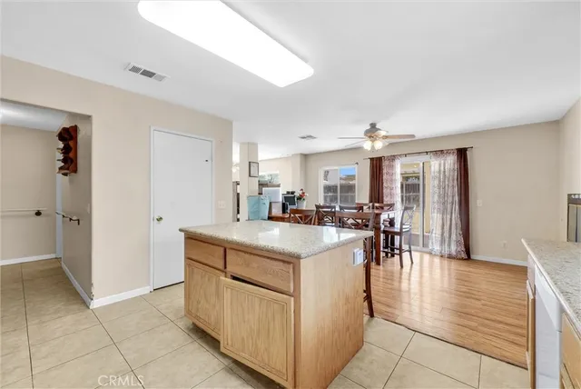 a view of kitchen with furniture and refrigerator