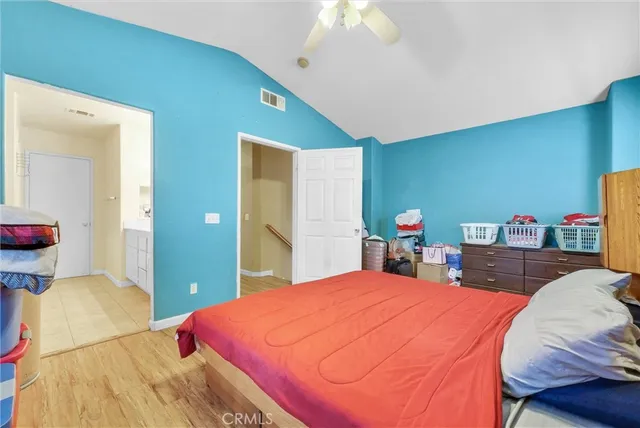 a bed room with a bed and a chandelier