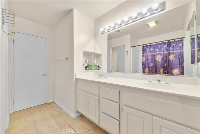 a bathroom with a sink double vanity and a mirror