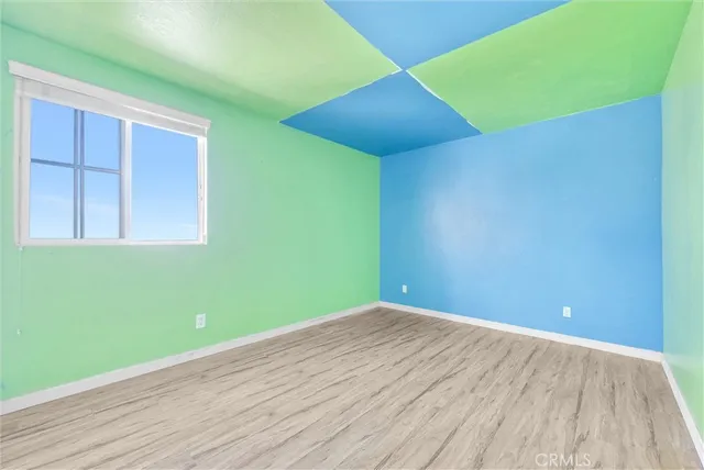 a view of a room with wooden floor
