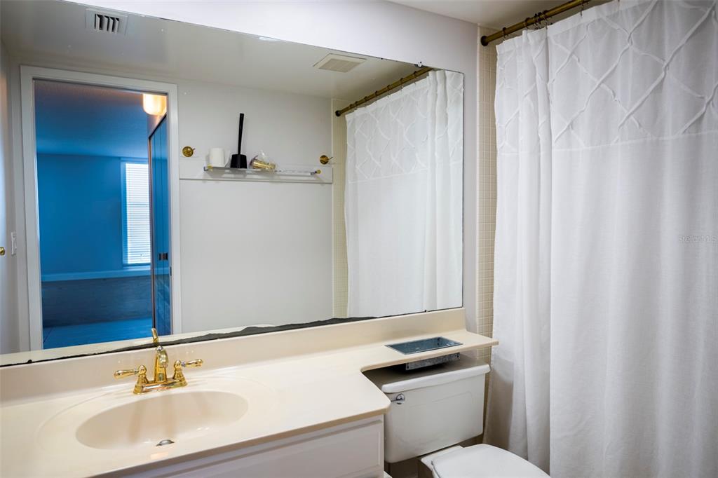 7100 Sunset Way, Unit 810 St. Pete Beach, FL 33706 - Photo 13 of 42 a bathroom with a sink and a toilet