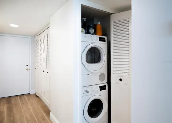 a bathroom with a sink a toilet a mirror and shower