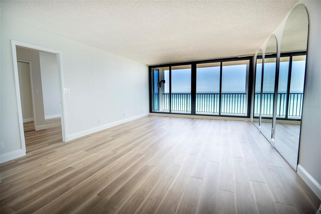 7100 Sunset Way, Unit 810 St. Pete Beach, FL 33706 - Photo 19 of 42 wooden floor in an empty room with a window
