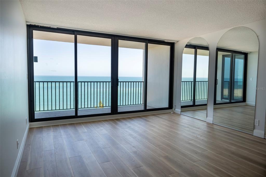 7100 Sunset Way, Unit 810 St. Pete Beach, FL 33706 - Photo 2 of 42 wooden floor in an empty room with a window
