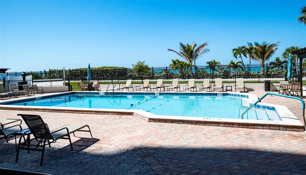 7100 Sunset Way, Unit 810 St. Pete Beach, FL 33706 - Photo 24 of 42 a view of a swimming pool with lounge chair
