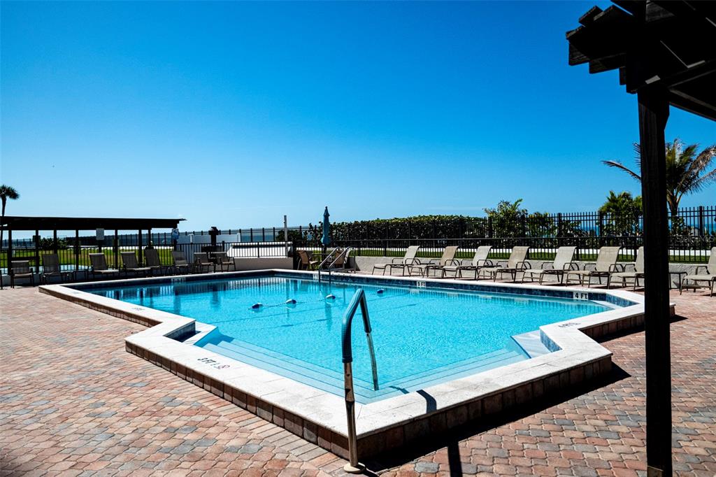 7100 Sunset Way, Unit 810 St. Pete Beach, FL 33706 - Photo 25 of 42 a view of a swimming pool with seating space