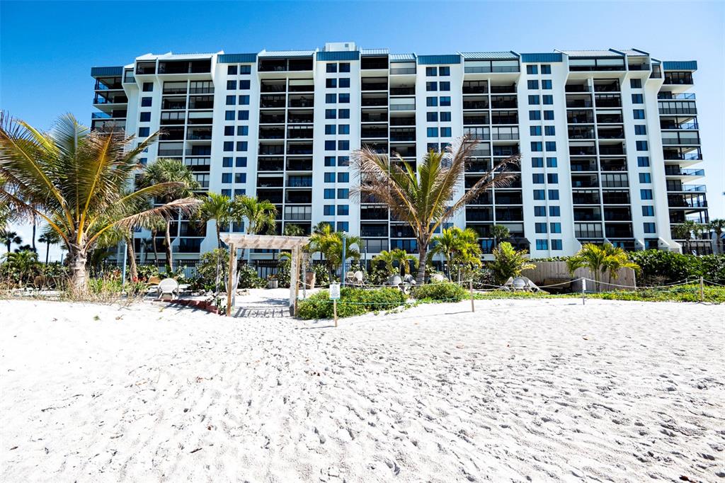 7100 Sunset Way, Unit 810 St. Pete Beach, FL 33706 - Photo 33 of 42 a front view of a building with a yard