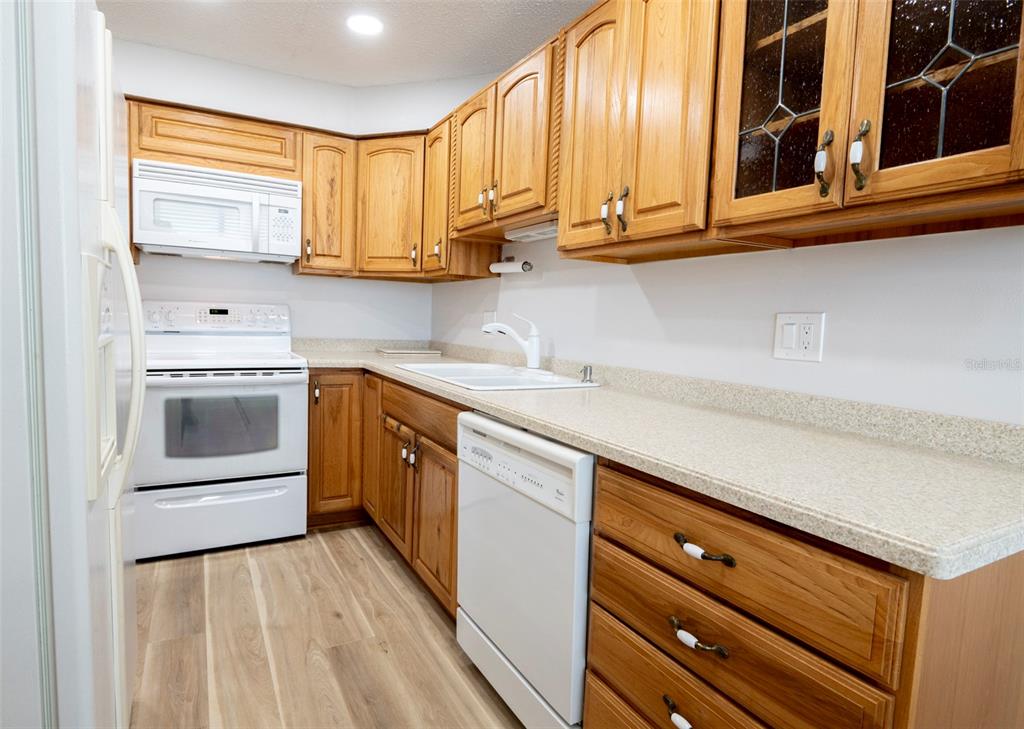 7100 Sunset Way, Unit 810 St. Pete Beach, FL 33706 - Photo 6 of 42 a kitchen with stainless steel appliances granite countertop a sink a stove and cabinets