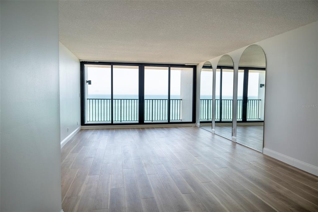 7100 Sunset Way, Unit 810 St. Pete Beach, FL 33706 - Photo 7 of 42 wooden floor in an empty room with a window