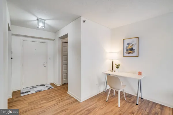 a view of a workspace with wooden floor