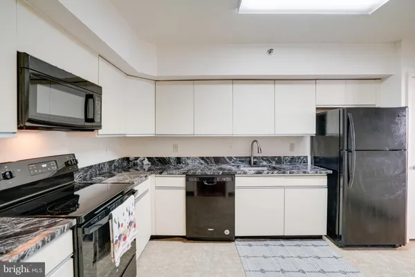 a kitchen with a stove top oven cabinets and stainless steel appliances