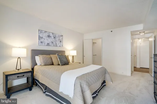 a bedroom with a bed and lamp