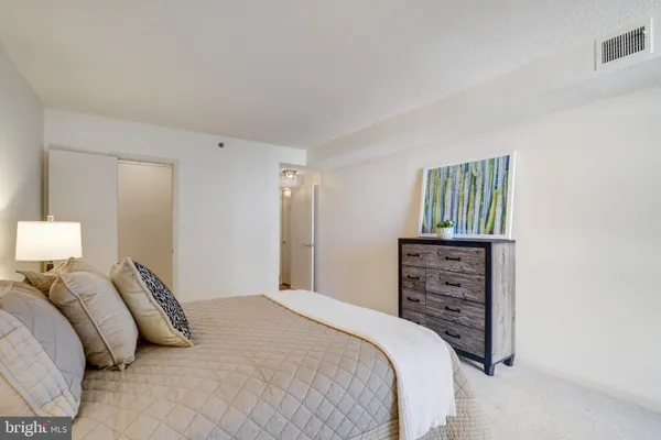 a bedroom with a bed and a lamp